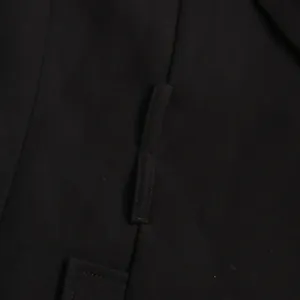Detailed close-up of a black waist-slimming blazer showing its strap and stitching.