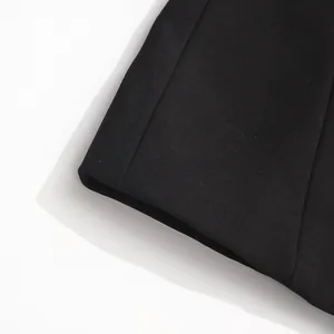 Close-up of high-quality black fabric texture and stitching on a professional blazer.