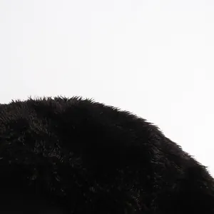 Macro view of soft plush black faux fur collar texture on elegant tailored blazer jacket
