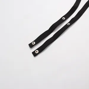 Close-up of black detachable waist straps with silver snap buttons for blazer jacket