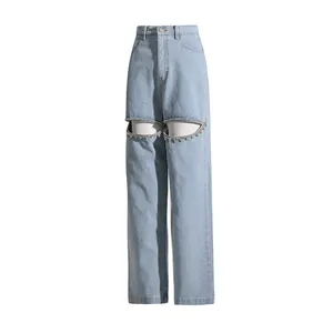 Stylish light blue high-waisted wide-leg jeans featuring unique cutout rhinestone details