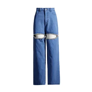 Detail view of high-waist wide-leg jeans with unique rhinestone cutout knee design.