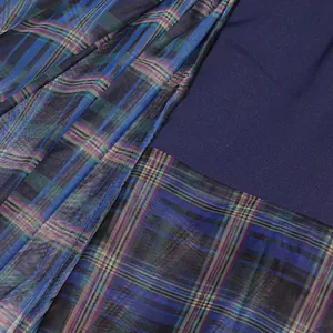 Detail view of navy blue and plaid mesh patchwork skirt showing fine fabric texture