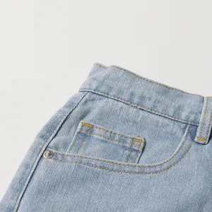 Close-up detail of high-waist light blue denim jeans showing pocket and stitching