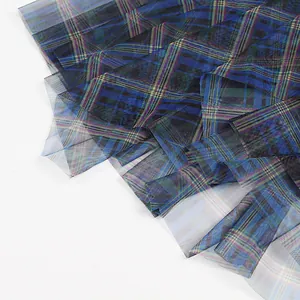 Close-up detail of blue and green plaid mesh fabric on the A-line midi skirt hemline.