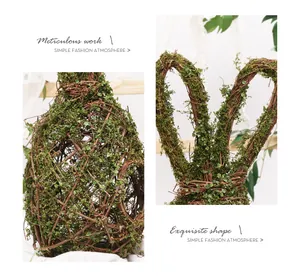 Detailed view of handcrafted natural vine rabbit decoration with green moss texture