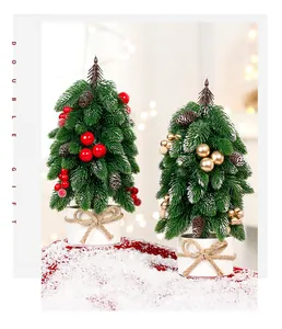 Miniature tabletop Christmas trees with pinecones and ornaments on artificial snow