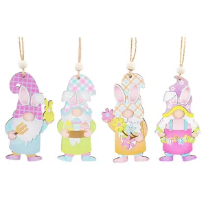 Four cute Easter gnome wooden hanging ornaments with bunny ears and colorful designs.