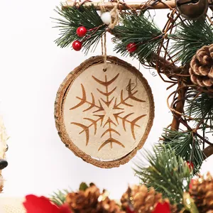 Rustic round wood slice Christmas ornament with engraved snowflake pattern for holiday decor.