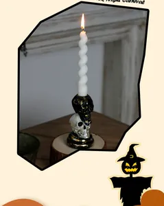 Gothic skull candlestick holder with white spiral candle for Halloween home decoration.