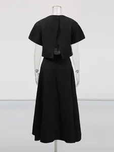 Elegante conjunto negro de dos piezas con top de manga corta y falda larga de línea A