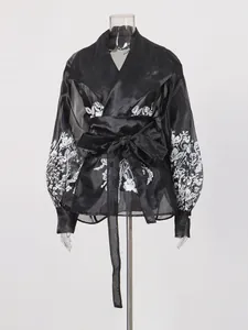Elegant black palatial style lantern sleeve blouse with white floral print and waist tie