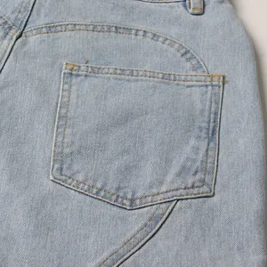 Macro view of back pocket detail and contrast stitching on light blue denim jeans