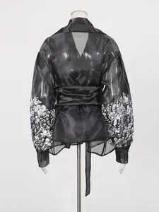 Elegant black sheer lantern sleeve blouse with white floral print and adjustable waist tie