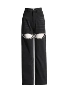Premium high-waisted black wide-leg jeans featuring unique rhinestone-encrusted cutouts.