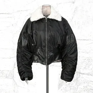 Detail view of black retro jacket with white faux fur collar and unique ruched sleeves design