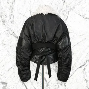 Back view of black cropped jacket featuring white fur collar and pleated sleeves