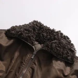 Close-up detail of a brown retro jacket with a curly faux fur collar