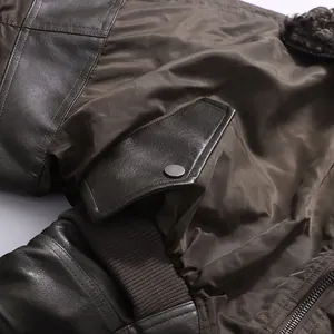 Macro detail of a brown vintage style jacket showing leather patches and pleated cuffs