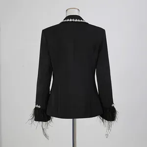 Detail view of back of black blazer with rhinestone collar and feather cuffs