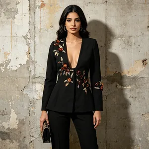 Elegant black blazer featuring detailed 3D floral applique and a plunging V-neckline.