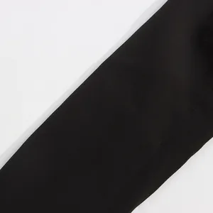 Close-up macro shot of black textured fabric from a high-end women's blazer jacket
