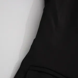 Close-up detail of high-quality black fabric texture on a women's tailored suit jacket