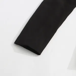 Close-up detail of a minimalist black blazer sleeve cuff with premium fabric stitching