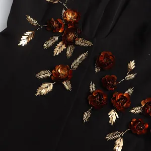 Detailed macro shot of heavy 3D copper sequin flowers on black designer blazer jacket