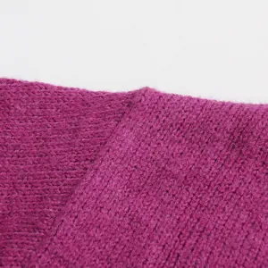 Detailed close-up of the purple knit fabric texture and seam for a women's cozy sweater.