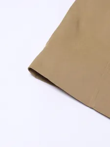 Close-up detail of khaki trench coat fabric and high-quality stitching