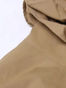 Macro detail of camel trench coat twill fabric with precision stitching and texture
