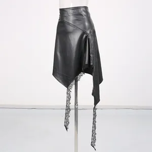 Detail of asymmetric black leather skirt with delicate lace patchwork hem