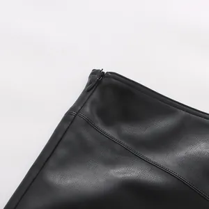 Close-up shot showing the hidden zipper and fine stitching of a black faux leather skirt