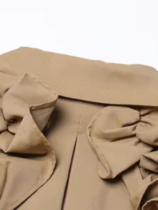 Detailed macro view of khaki trench coat featuring elegant ruffled lotus leaf edge stitching