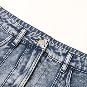 High-quality macro detail of high-waisted denim skirt featuring a metallic button closure.