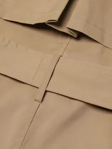 Macro view of high-quality khaki trench coat fabric and precise stitching detail