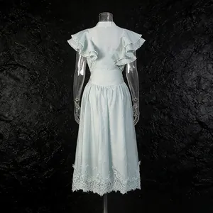 Back view of romantic light blue dress set with ruffle sleeves and lace hem details.
