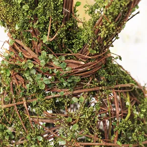 Close-up of Nordic style natural vine rabbit Easter decoration with green moss details