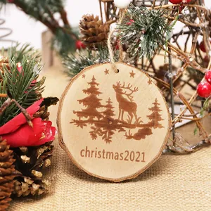 Rustic round wooden Christmas ornament with deer and tree engraving for holiday decor.