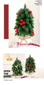 Detailed view of artificial mini Christmas trees with festive berries and snow-flocked branches