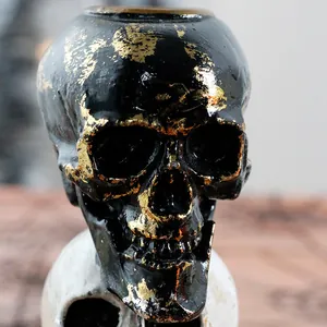 Gothic black resin skull candle holder with gold foil finish for Halloween home decor