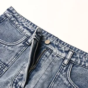 Close-up of high-waist denim skirt with metal button and zipper fly details