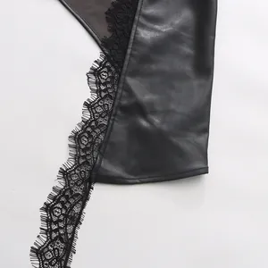 Close-up detail showing the texture of black faux leather and intricate floral lace trim