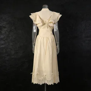 Back view of a vintage cream dress set with ruffled sleeves and delicate lace hem