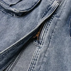 Macro close-up detail of cargo denim skirt featuring metal zipper and high-quality fabric