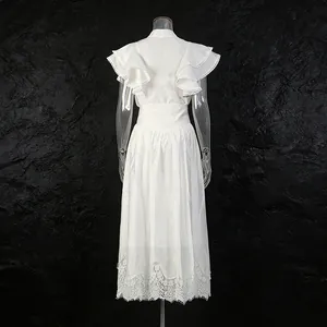 Back view of white retro dress set with flutter sleeves and elegant lace hem details.