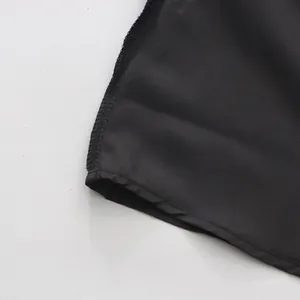 Close-up macro view showing the fine stitching and smooth texture of the black leather skirt