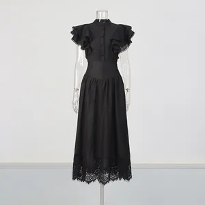 Detailed view of black retro romantic ruffled top and high waist lace hem skirt suit