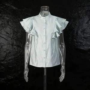 Close-up of light blue flutter sleeve blouse with delicate pom-pom lace trim detail.